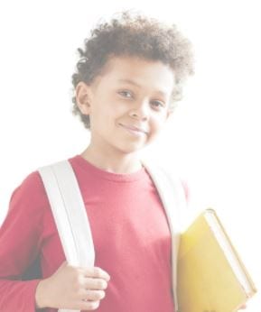 Little boy carrying a book