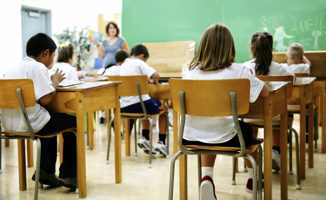 View of students sitting in desks in a classroom