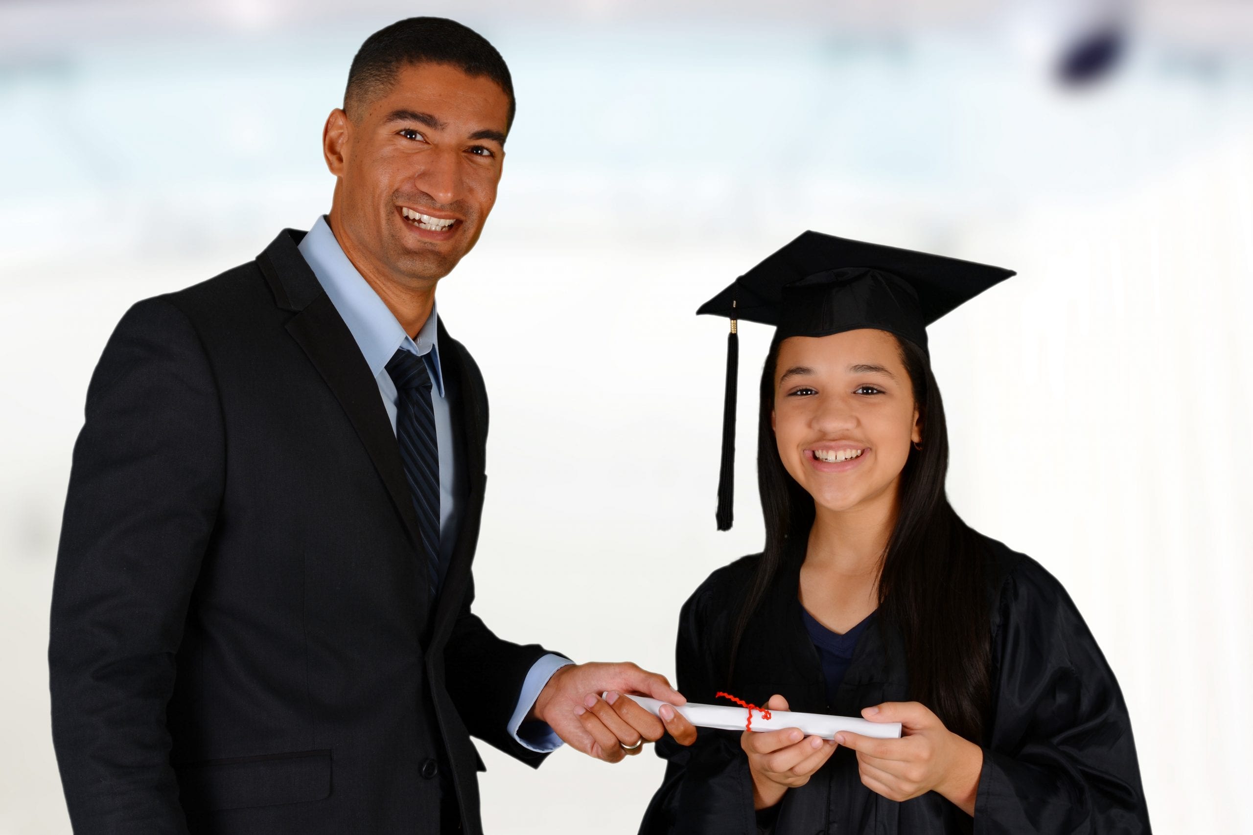 A Principal handing a graduate her diploma