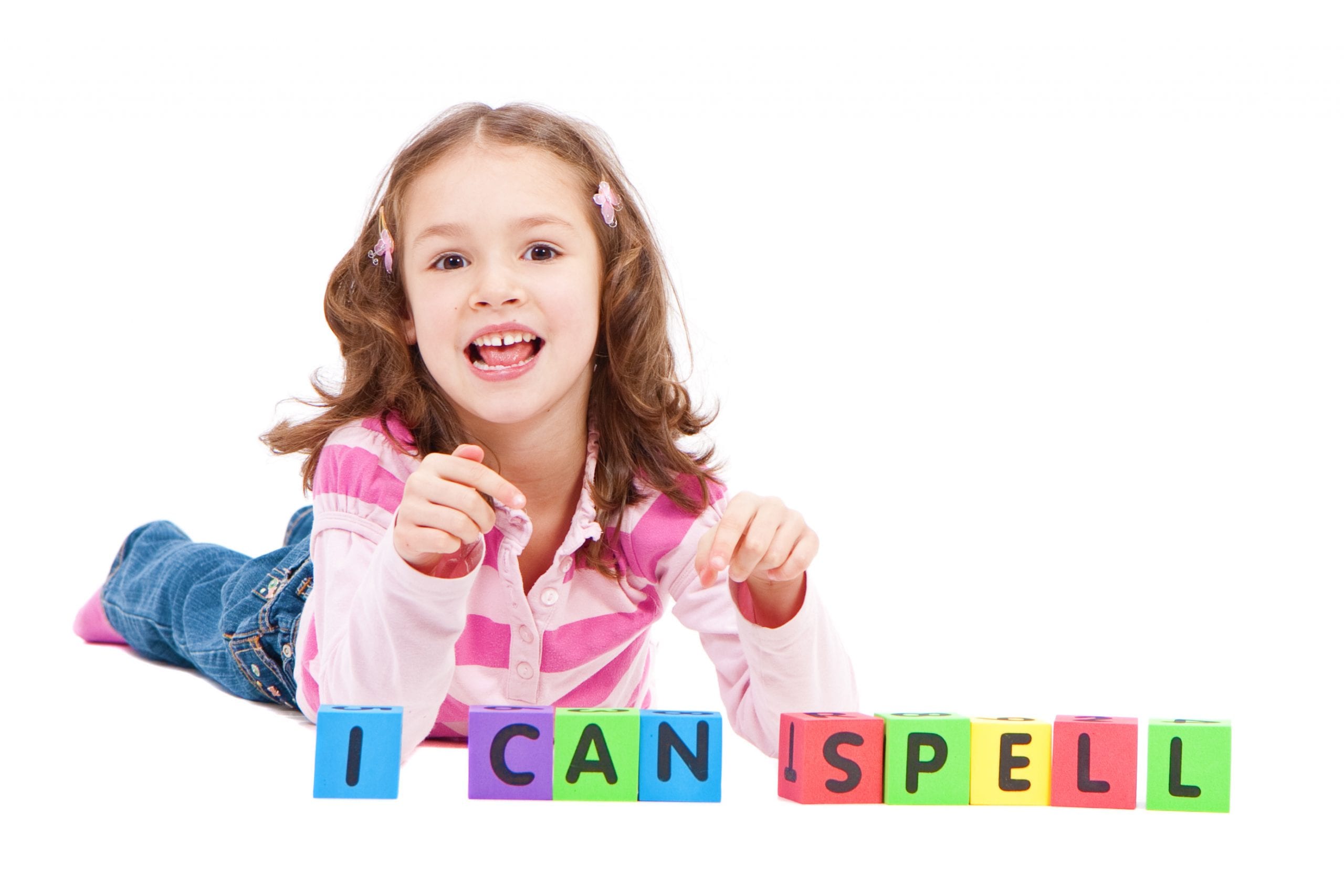 A little girl spelling with letter blocks