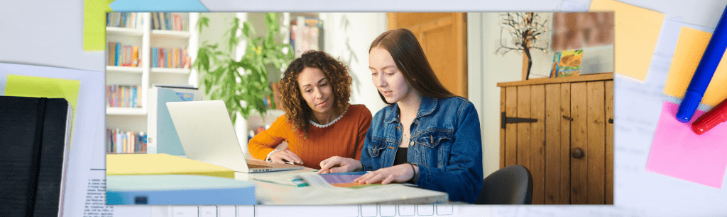 female student works with female tutor at desk